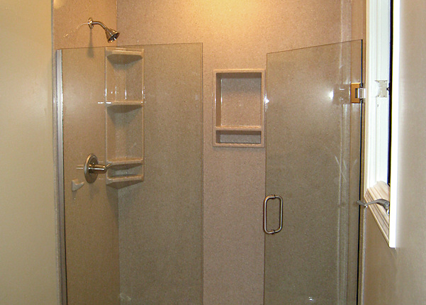 Modern glass shower enclosure with sleek fixtures and tiled walls.