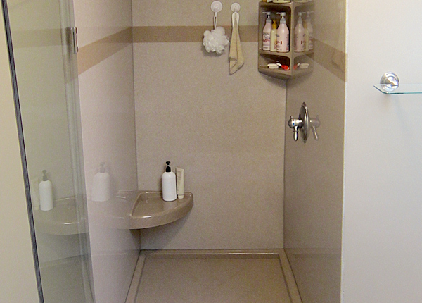 Clean shower area with tiled walls and floor.
